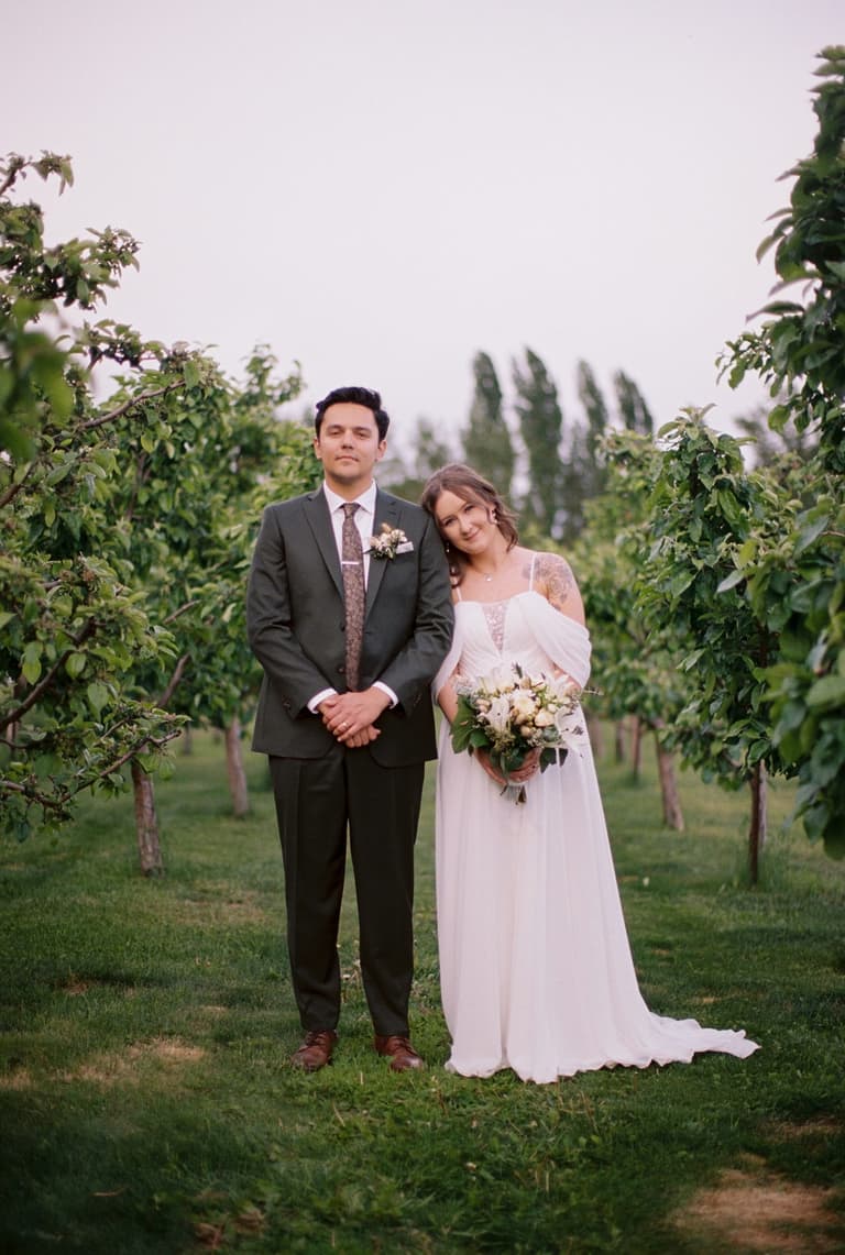 Pensive bride behind glowing taper candles and blue glass goblets