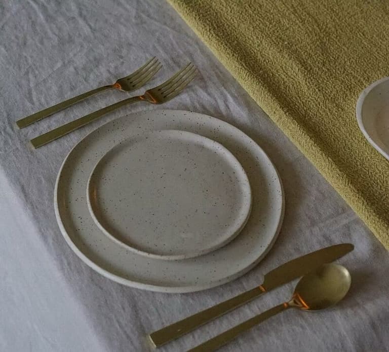 Speckled stoneware and gold flatware from Moss & Minto