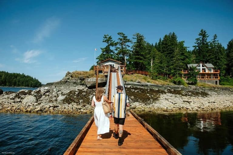 Newlyweds walking on dock on Quadra Island