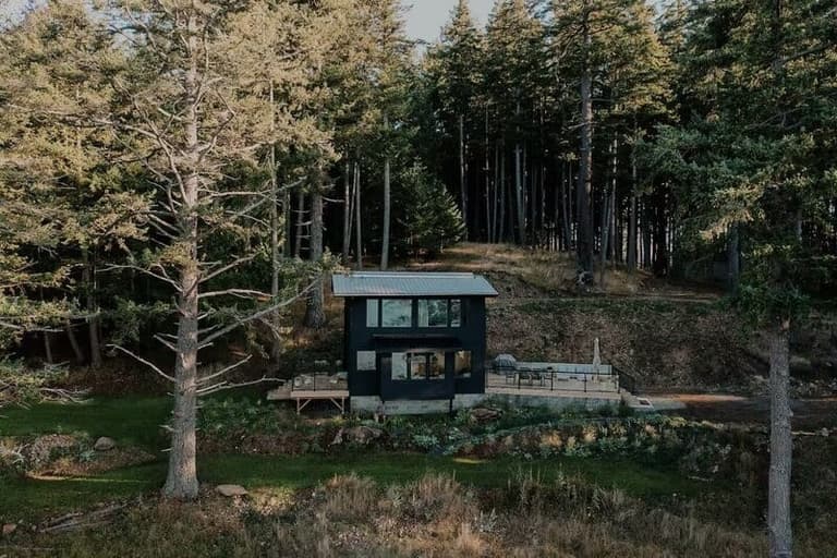 Norra Han's hillside cabin and deck on forested Hornby Island