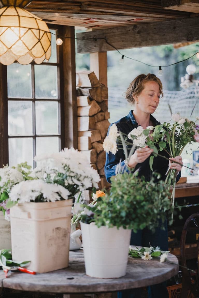 Florist arranging white blooms in the Buttercup Sandwich Florals studio