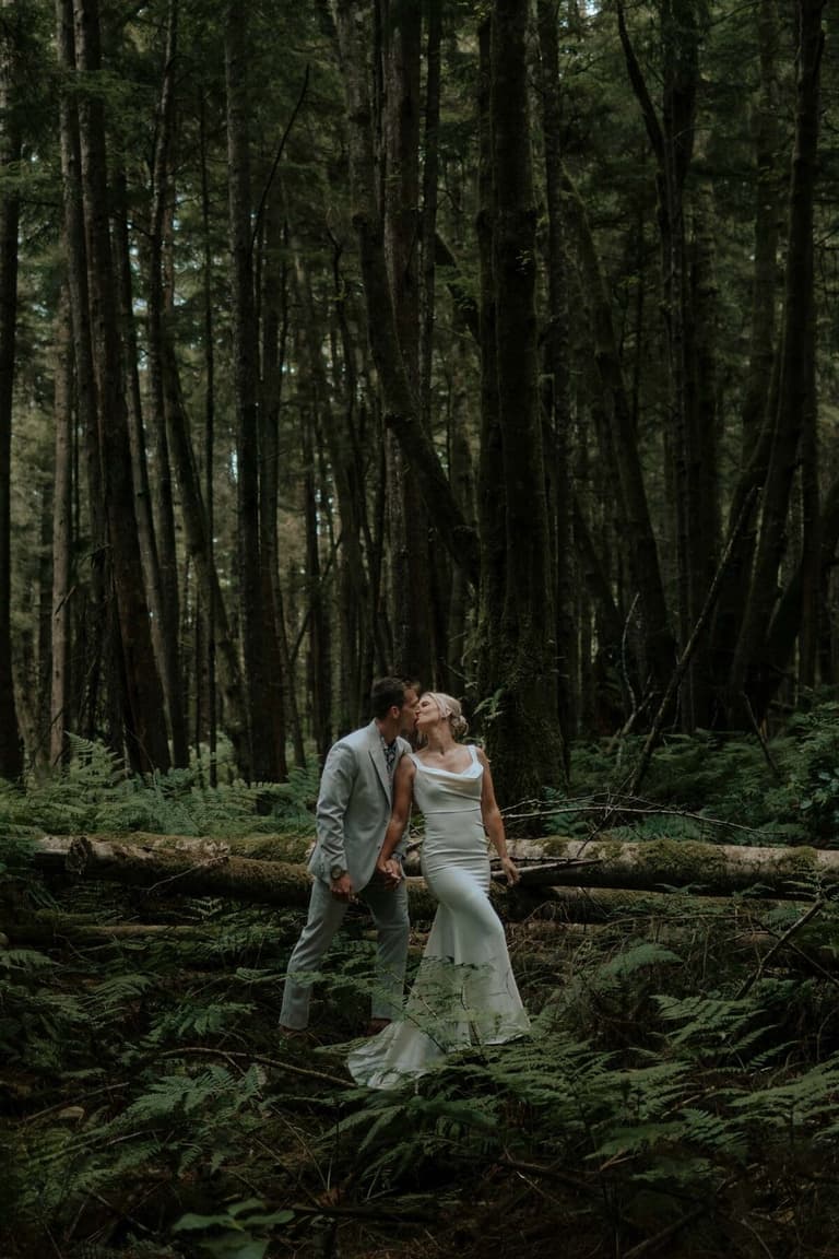 Couple embracing among ferns in an old-growth forest