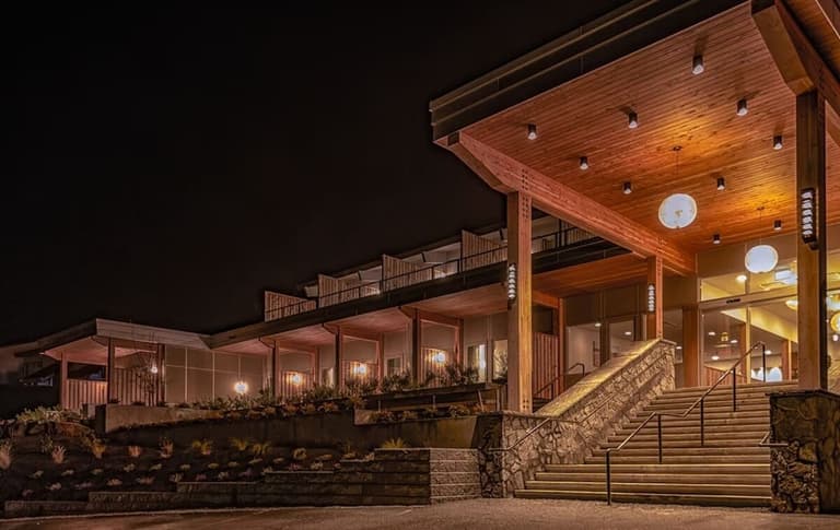 Harbour House Hotel's timber entrance and stone staircase lit at night
