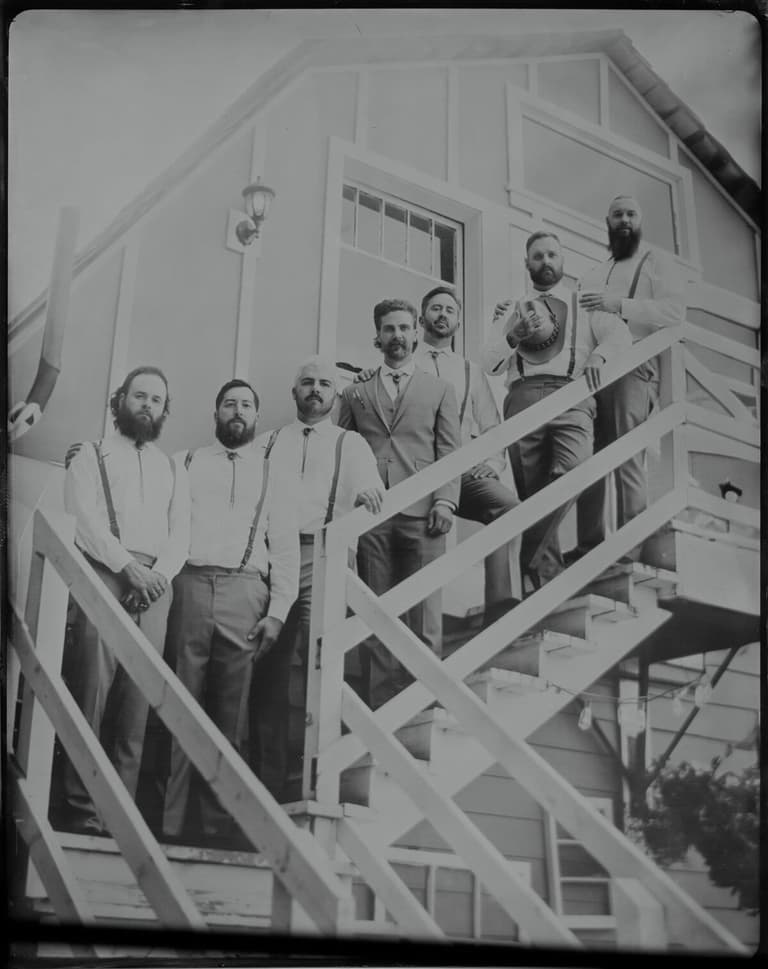 Groomsmen gathered on an outdoor staircase, wet-plate group shot